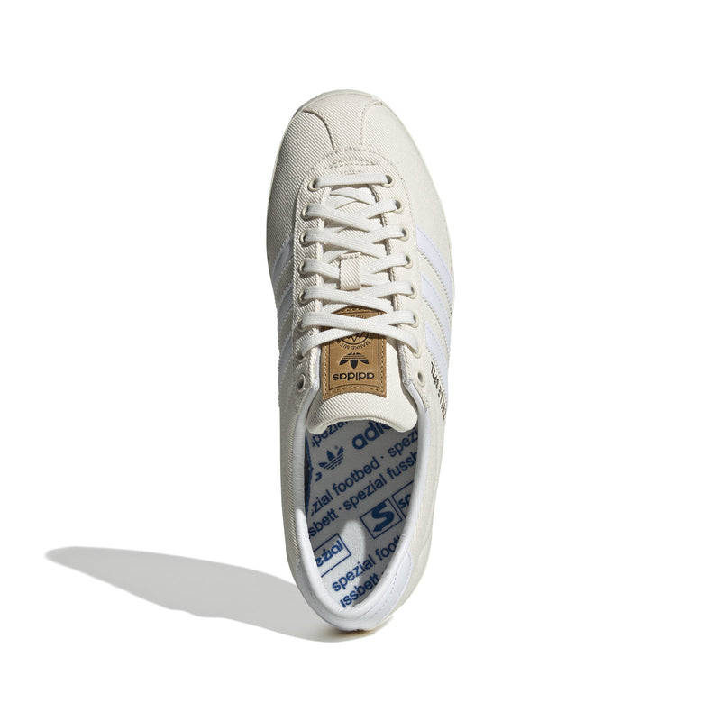 Gazelle shoes featuring a low-top design with a white denim upper, complemented by a leather lining for comfort and a rubber outsole for stability.