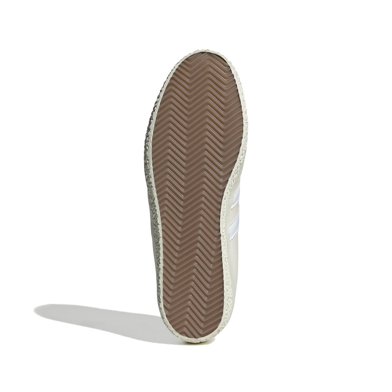 Gazelle shoes featuring a low-top design with a white denim upper, complemented by a leather lining for comfort and a rubber outsole for stability.